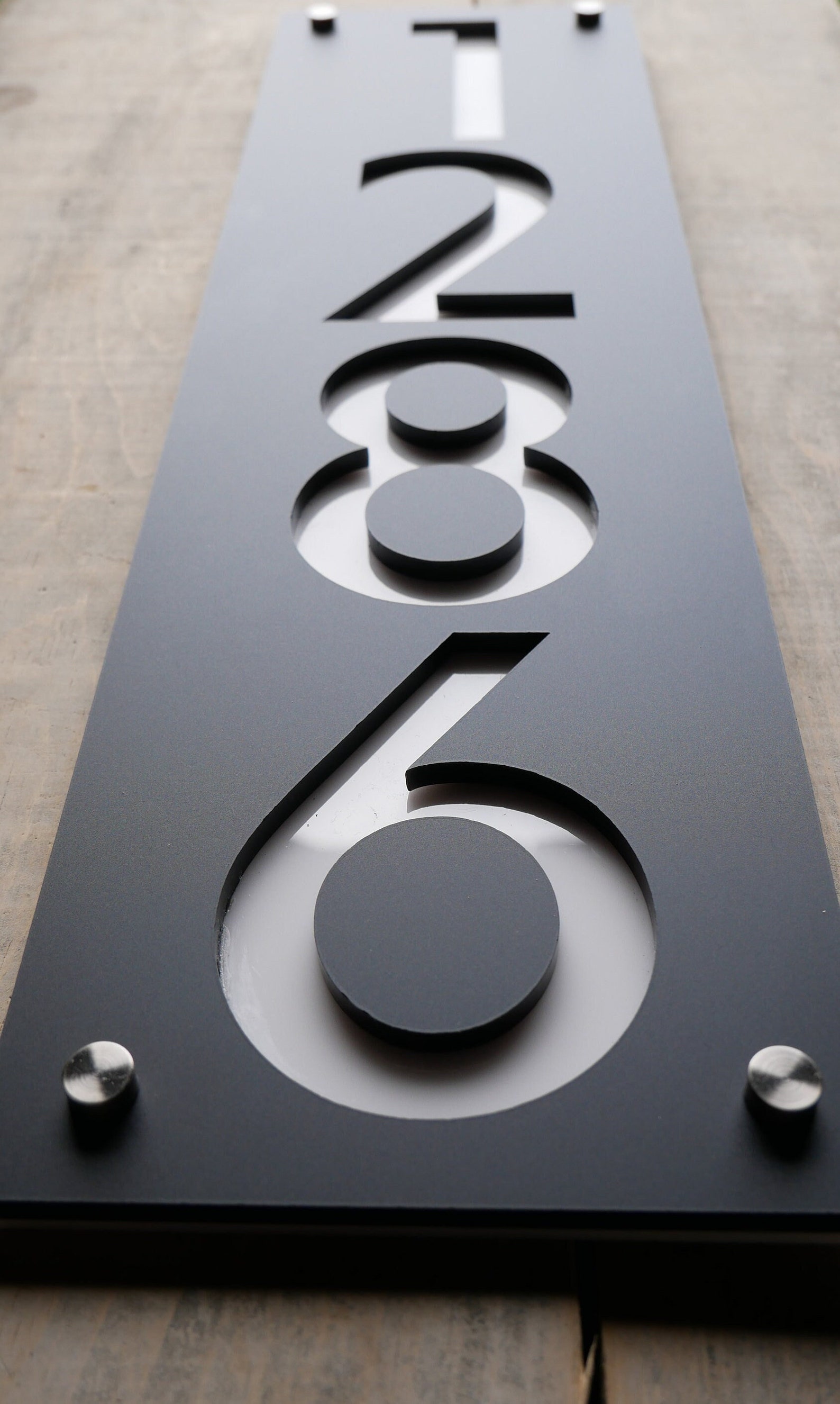 Multi-dimensional unit number 1286 with clean contemporary typography made of black and white acrylic.