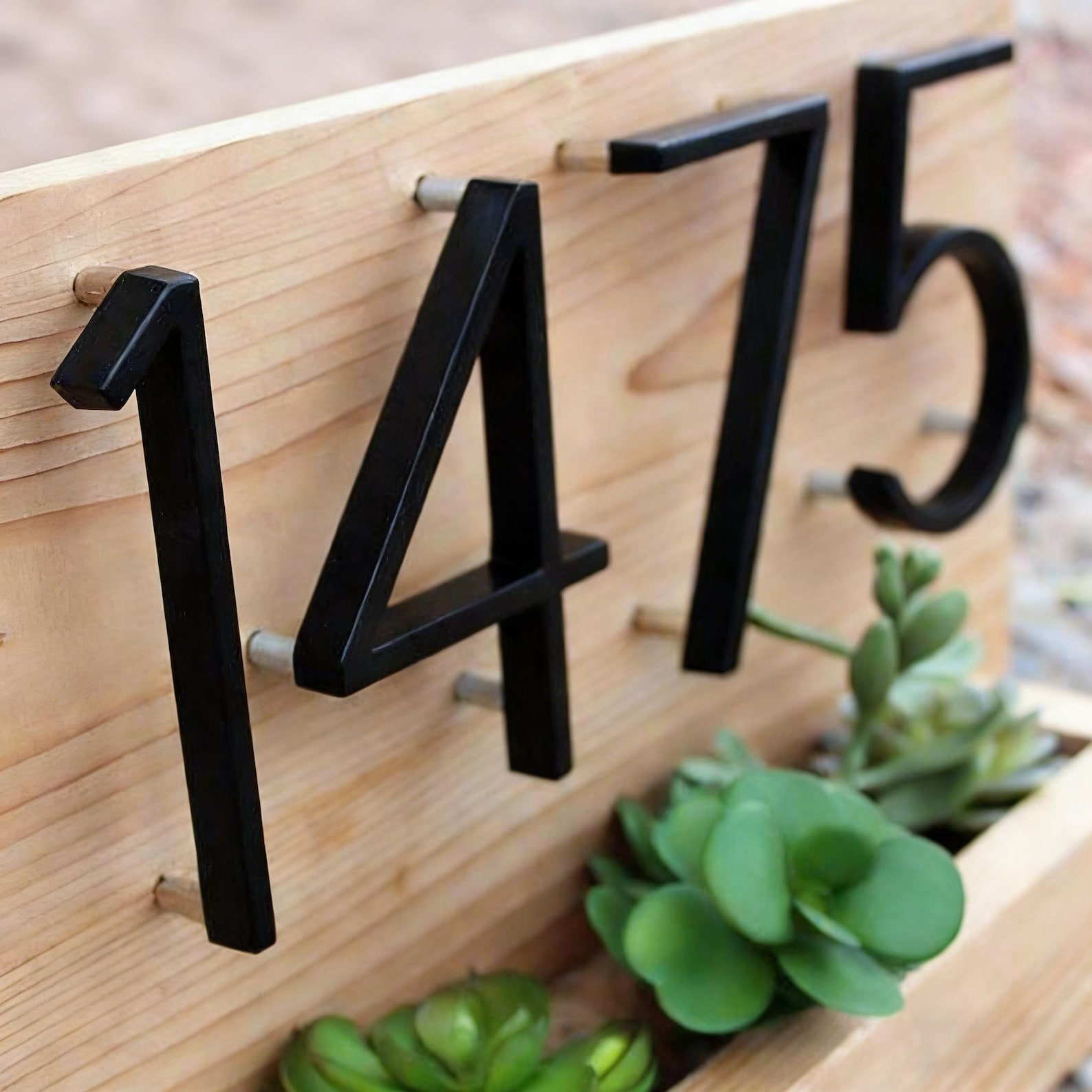 Dimensional unit marker 1475 mounted on pine with numbers made of painted HDU with a bold slab-serif face.