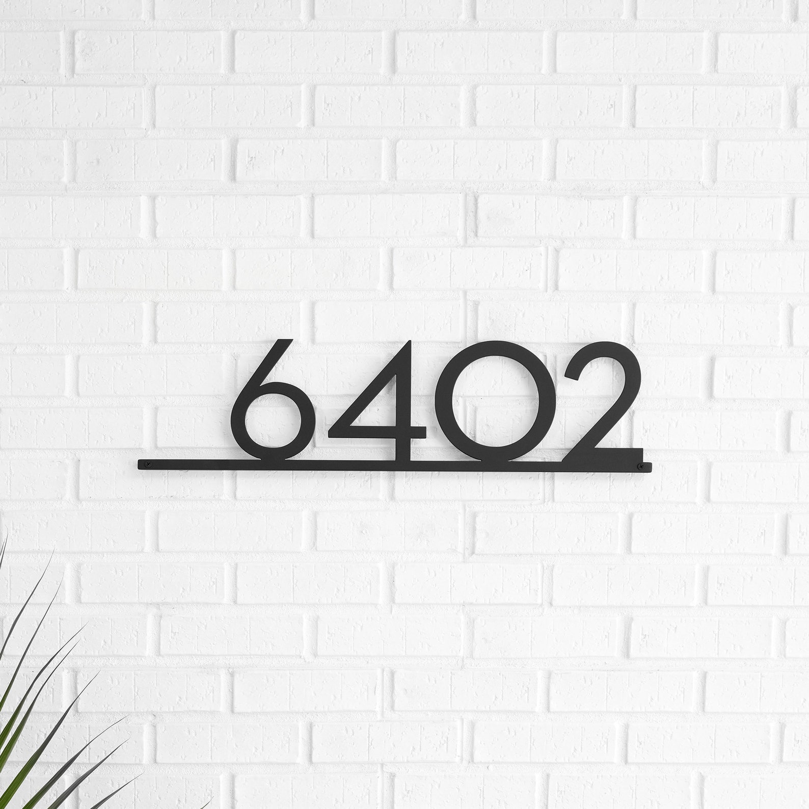Large-format street address numerals — 6402 — in powder-coated aluminum.