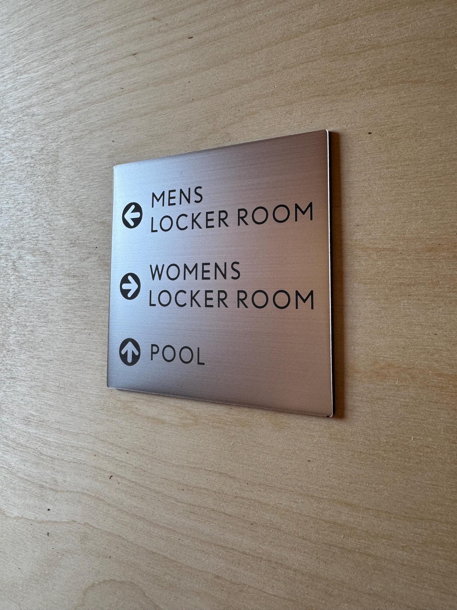 Interior gym sign on brushed stainless with vinyl lettering. 